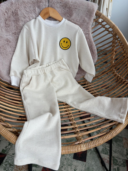 Crème broek met vrolijke gele smiley