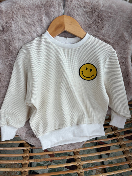 Crème sweater met vrolijke gele smiley